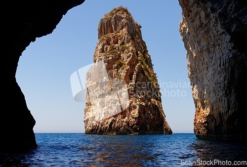 Image of Majestic Ortholithos Rock in sea near Paxos island, Greece, seen through the cave entrance