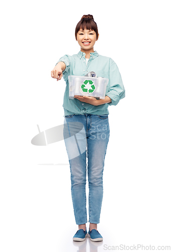 Image of smiling young asian woman sorting metallic waste