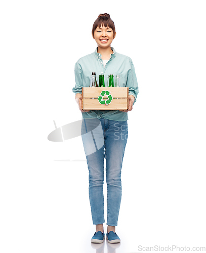 Image of smiling young asian woman sorting glass waste