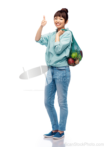 Image of woman with food in string bag showing thumbs up