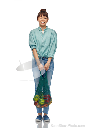 Image of happy asian woman with food in reusable string bag