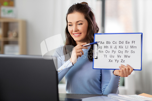 Image of teacher with alphabet having online class at home