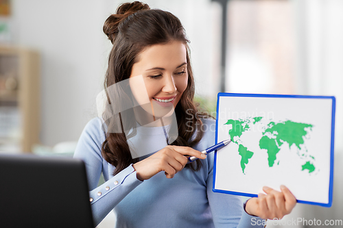 Image of teacher with world map having online class at home