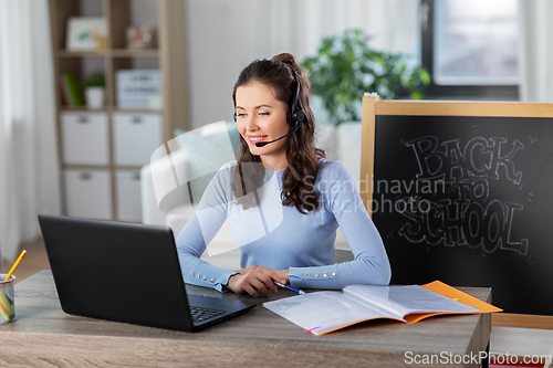 Image of teacher with laptop having online class at home