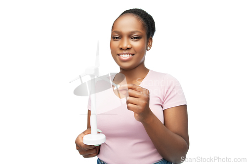 Image of happy african american woman with toy wind turbine