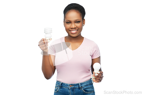Image of african american woman holding lighting bulbs