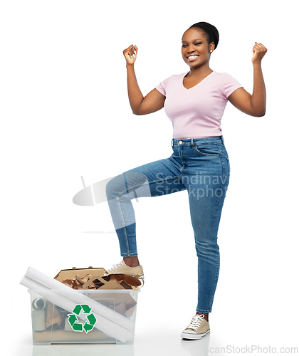 Image of happy african american woman sorting paper waste