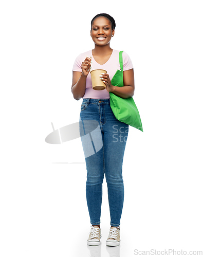 Image of happy woman with reusable bag for food and wok