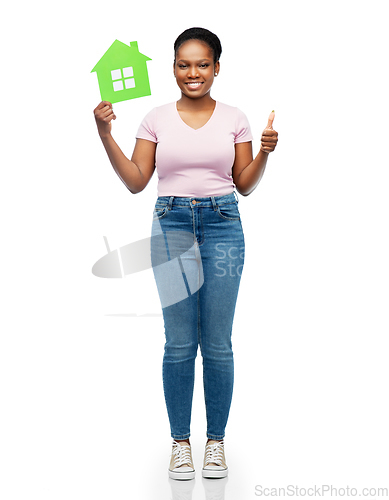 Image of smiling african american woman holding green house