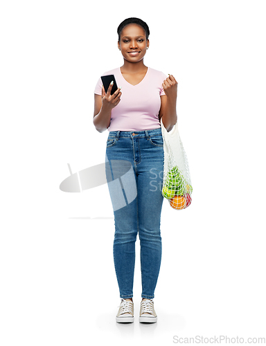 Image of woman with smartphone and food in string bag