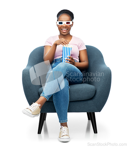 Image of woman in 3d movie glasses eating popcorn in chair