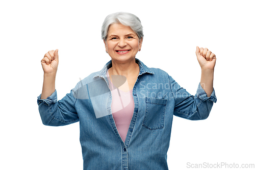 Image of portrait of smiling senior woman in denim shirt
