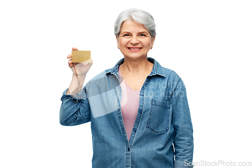 Image of portrait of smiling senior woman with credit card