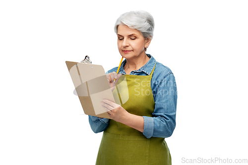 Image of senior woman in garden apron with clipboard
