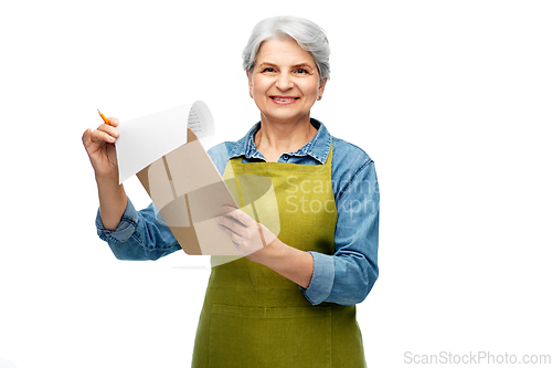 Image of smiling old woman in garden apron with clipboard