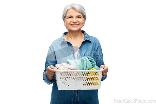 Image of smiling senior woman with laundry basket