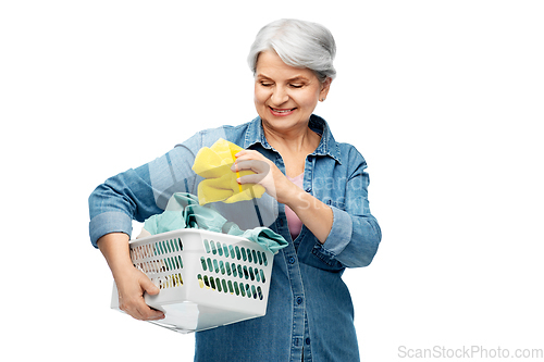 Image of smiling senior woman with laundry basket