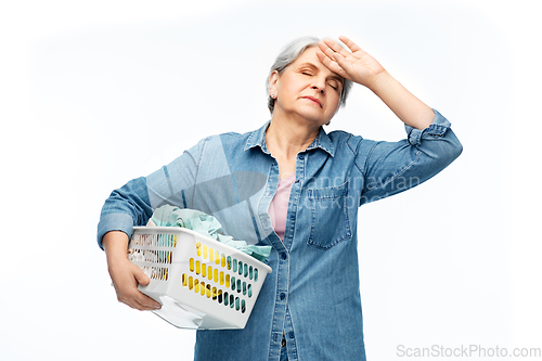 Image of tired senior woman with laundry basket