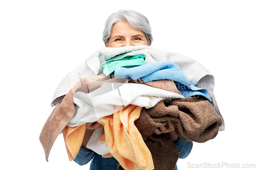 Image of senior woman with heap of bath towels