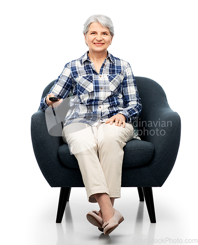 Image of happy senior woman watching tv sitting in armchair