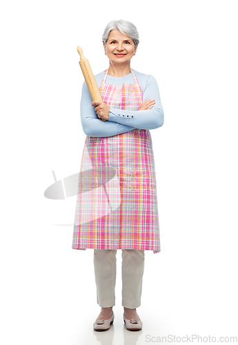 Image of smiling senior woman in apron with rolling pin