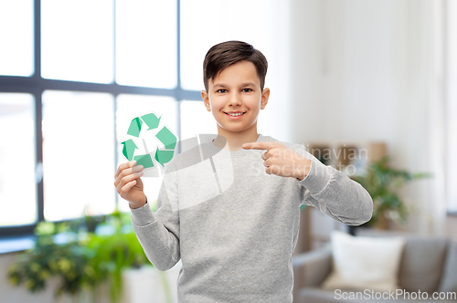 Image of smiling boy showing green recycling sign