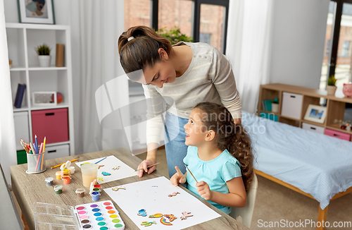 Image of mother with little daughter drawing at home