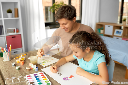 Image of happy father with little daughter drawing at home