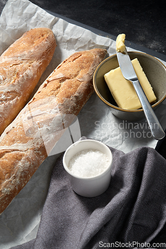 Image of close up of bread, butter and knife on towel