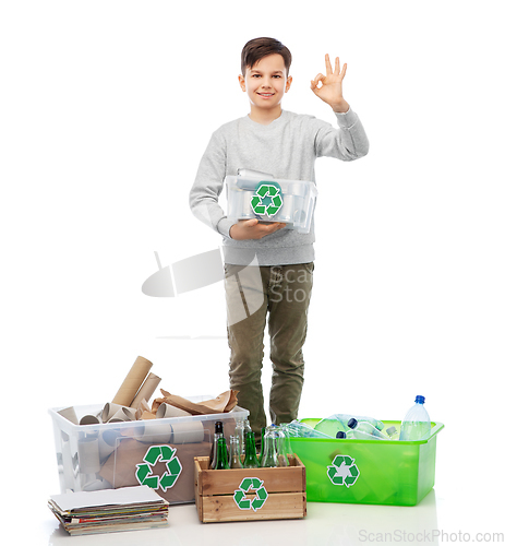 Image of smiling boy sorting paper, metal and plastic waste