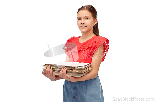 Image of smiling girl with magazines sorting paper waste