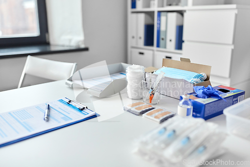 Image of syringes and medicine on table at hospital