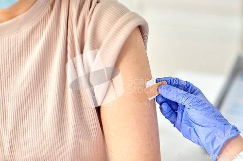 Image of close up of doctor attaching patch to patient