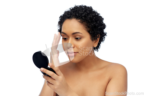 Image of african american woman looking to mirror