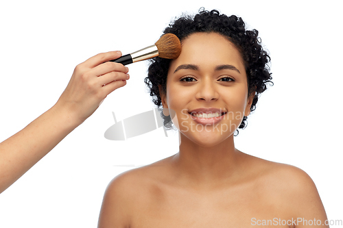 Image of happy woman and hand of make up artist with brush