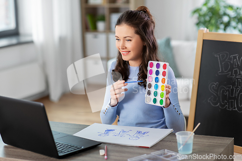 Image of teacher with colors having online class of arts