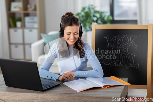 Image of teacher with laptop having online class at home