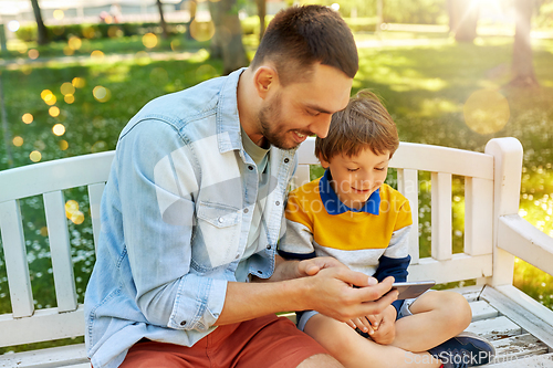 Image of father and son with smartphone at park