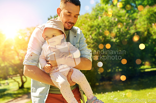 Image of happy father with baby daughter at summer park