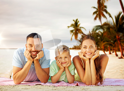 Image of happy family lying over tropical beach background