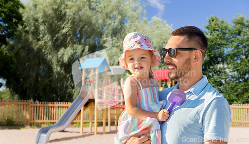 Image of happy father with little daughter on playground