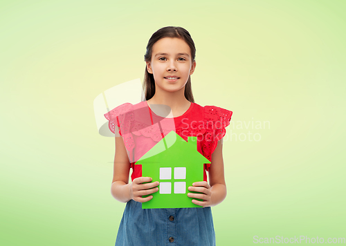 Image of smiling little girl holding green house icon