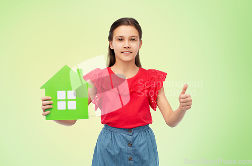 Image of happy girl with green house icon showing thumbs up