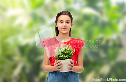 Image of happy smiling girl holding green flower in pot