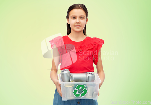 Image of smiling girl sorting metallic waste over green