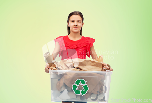 Image of smiling girl sorting paper waste over green