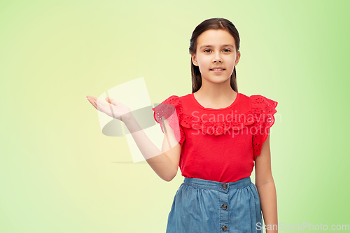 Image of happy smiling girl holding something on her hand