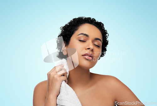 Image of young african american woman with bath towel