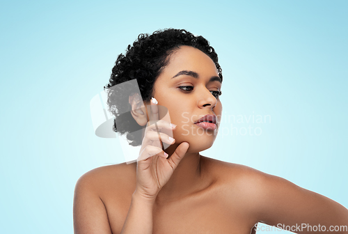 Image of young african american woman with moisturizer