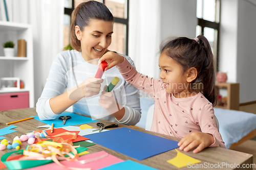 Image of daughter with mother making applique at home